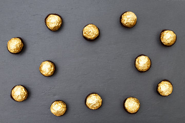 Truffles pattern, top view flat lay of various chocolate sweets. Minimal concept above decoration on black food background. Chocolate Candy, Truffle.