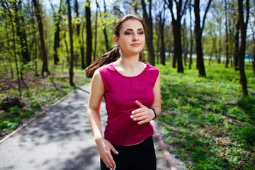 Young pretty fit woman jogging in the park.