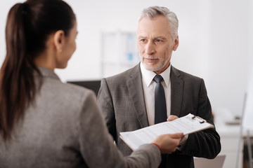 Handsome delighted male person taking documents