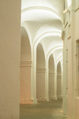 Row of marble arches and columns on the facade of old building