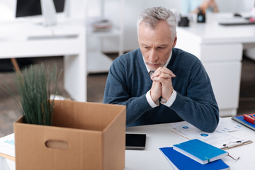 Thoughtful businessman keeping hands together