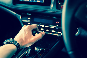 close up of hand on manual gear shift knob for car industrial concept