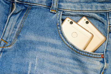 Modern smartphones in the old jeans pocket.