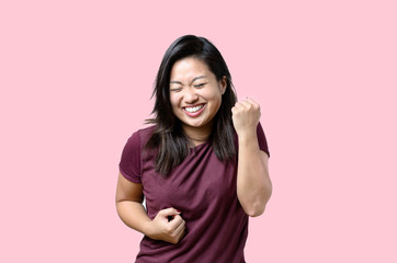 Exuberant young Chinese woman cheering