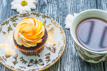 Still life with cup of tea and cake on the wooden background