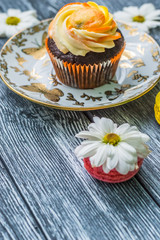 Still life with cup of tea and cake on the wooden background