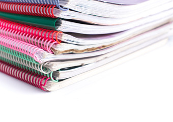 Stack of spiral bound notebooks on white background, office equipment