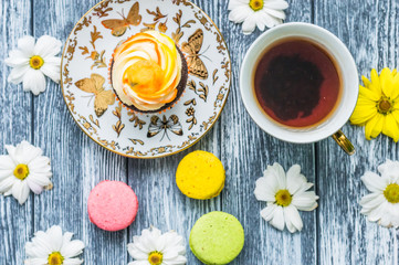 Still life with cup of tea and cake on the wooden background