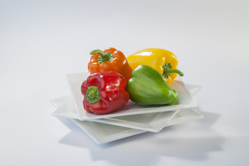 coloured bell peppers on white Background