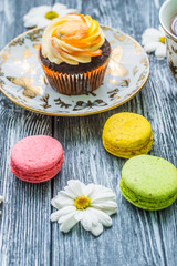 Still life with cup of tea and cake on the wooden background