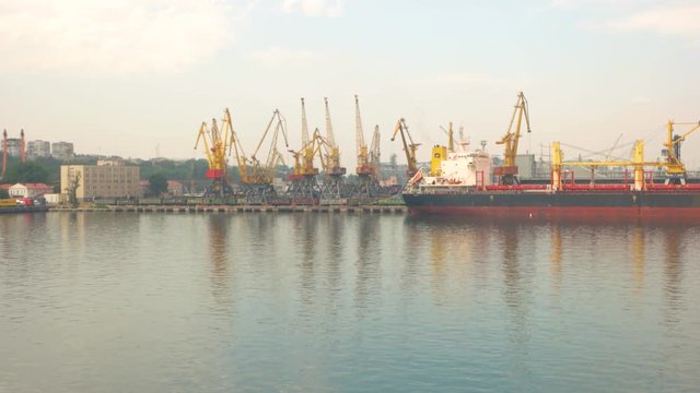Tanker and harbor cranes. Ship at the port. International shipping company.