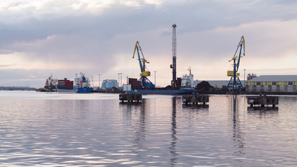 Fototapeta premium cranes at harbor against sky
