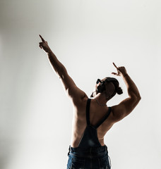 rear view - the rapper shirtless with headphones and stylish hai