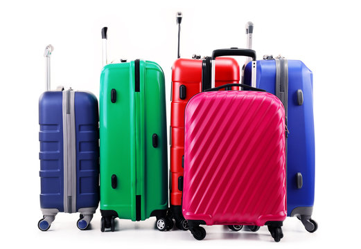 Five plastic suitcases isolated on white