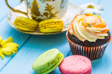 Still life with cup of tea and cake on the wooden background