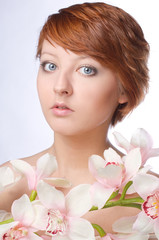 Beauty face of the young woman with flower