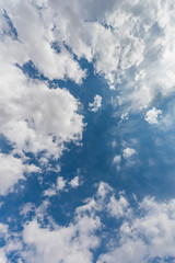Vertical skyscape of blue sky background with clouds