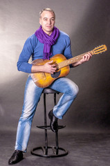 Fototapeta na wymiar Portrait of elegant man with a guitar