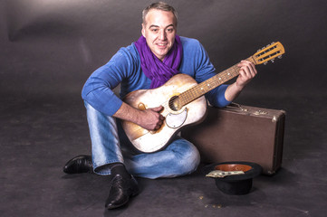 Portrait of elegant man with a guitar