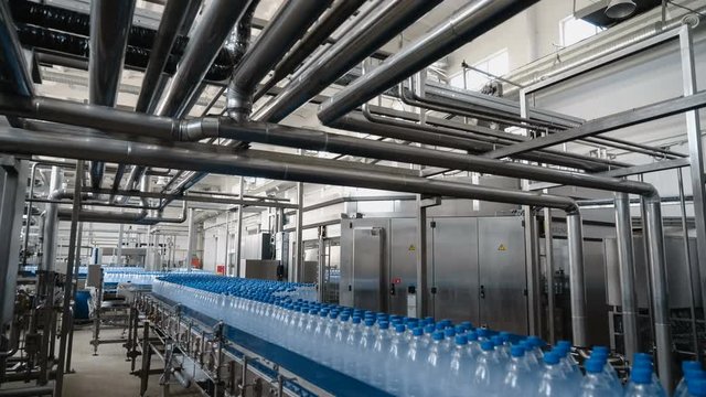 Water filling line - Water bottling line for processing and bottling pure mineral water into blue bottles.