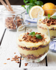 Healthy dessert in a glass with lemon cream and granola