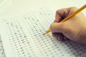 optical form of standardized test with answers bubbled and a black pencil examination,Answer...