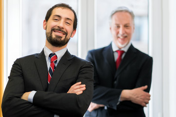 Smiling businessman in front of his boss
