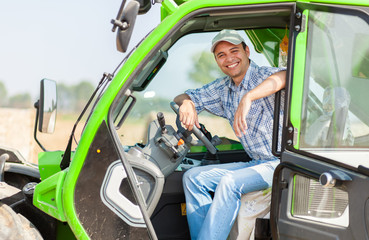 Portrait of a smiling farmer in his tractor