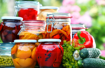 Jars of pickled vegetables and fruits in the garden