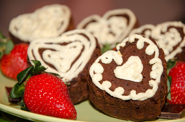 Heart shaped chocolate muffins and raspberries