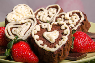 Heart shaped chocolate muffins and raspberries