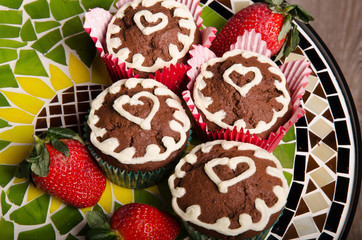 Heart shaped chocolate muffins and raspberries