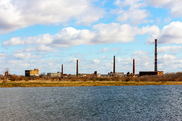 Old Abandoned chemical factory with chimneys on the banks of the river 2