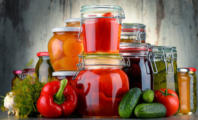 Jars with pickled vegetables and fruity compotes