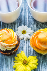Still life with cup of tea and cake on the wooden background