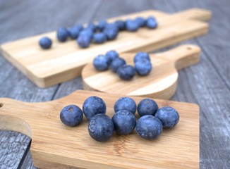 Fresh blueberries on bamboo cutting board