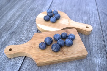 Fresh blueberries on bamboo cutting board