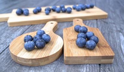 Fresh blueberries on bamboo cutting board