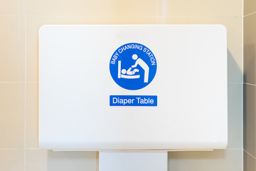 Baby's diaper table changing cloth station install in the wall at the airport restroom,selective focus