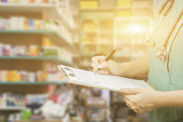 female doctor,surgeon,nurse,pharmacy with stethoscope on hospital holding clipboard,writing a prescription,Medical Exam,Healthcare and medical concept,test results,patient registration,selective focus