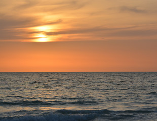 Naklejka na ściany i meble A beautiful sunset over the Gulf of Mexico on Indian Rocks Beach, Florida.