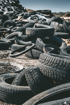Pile of old rotten rubber tires background