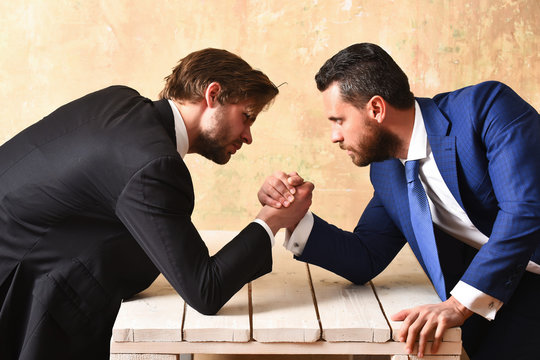 Brokers arm wrestling in office