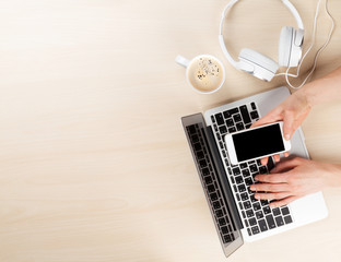 Obraz na płótnie Canvas Office desk with laptop, coffee and headphones