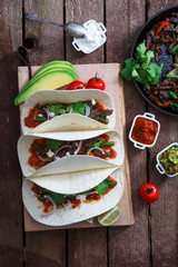 Above view of wheat wraps with mexican pork fajitas, selective focus