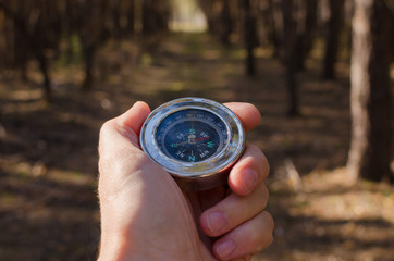 Male hand holding a compass