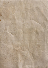 Old brown sheet of paper with spots and folds, texture