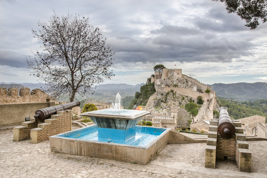 Bright blue fountain and two old cannons. Xativa Castle from the inside. Valencia region, Spain