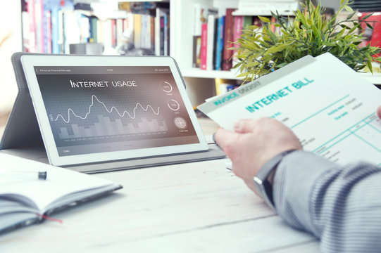 Tablet pc with internet usage application and man holds bill for internet. Internet usage application made in graphic program.