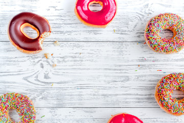 strawberry and chocolate donuts flat lay on wooden background top view mockup